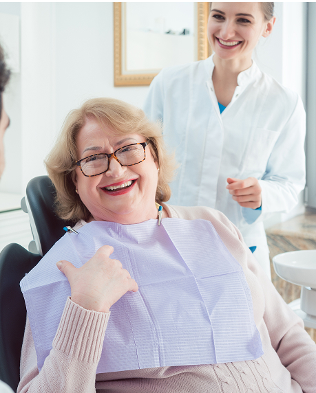 knightstreetdentists.com.au | Older woman smiling in a dental chair with a dental professional standing beside her.